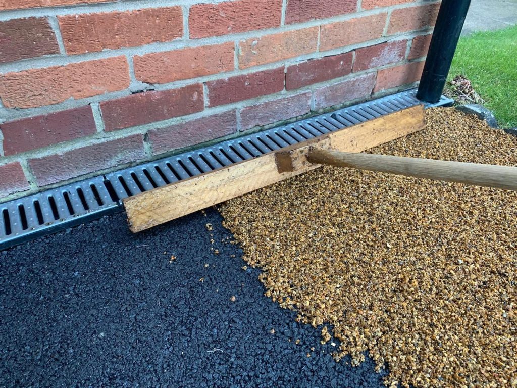 Installing a gold resin driveway. ACO drainage.