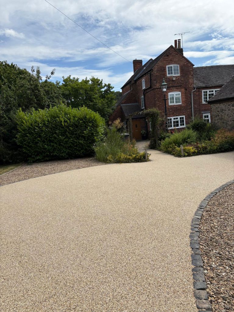 Large resin driveway to a home in Leicester. Cobblestone border to provide driveway restraint and prevent spread.