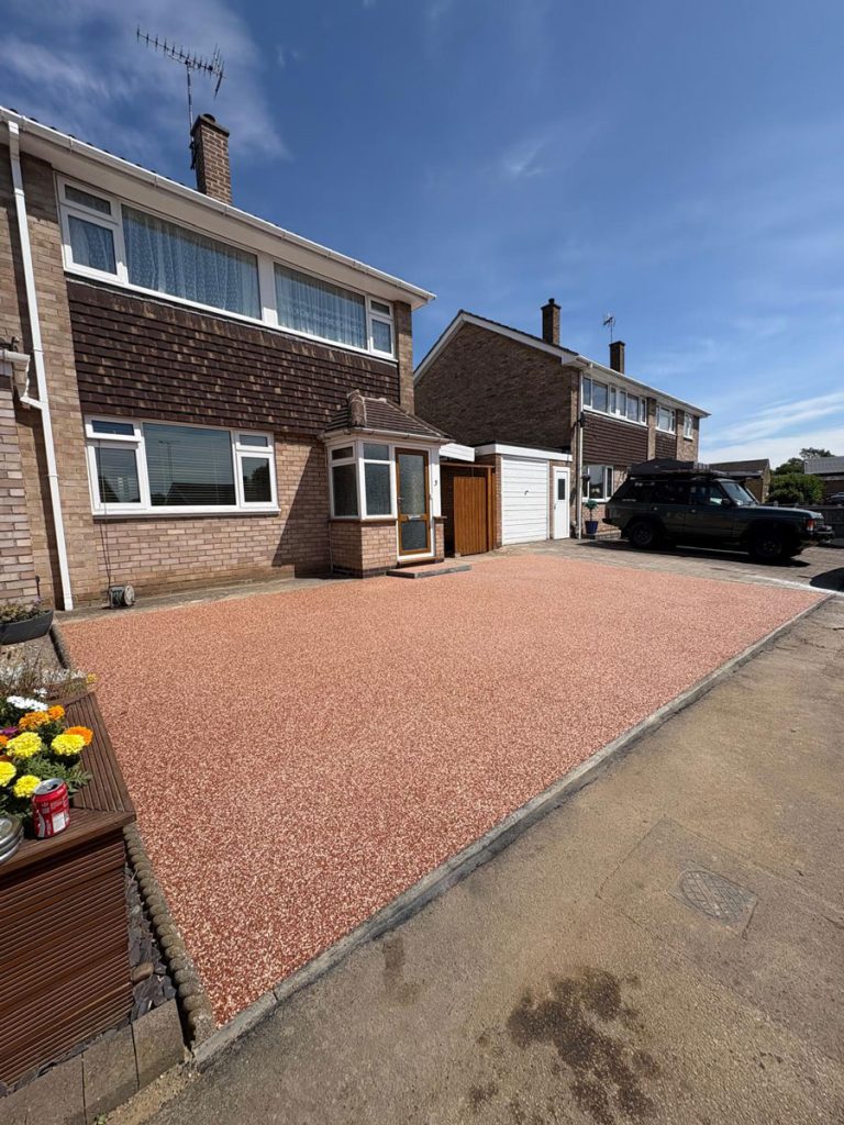 Red resin driveway in Loughborough with feature step.